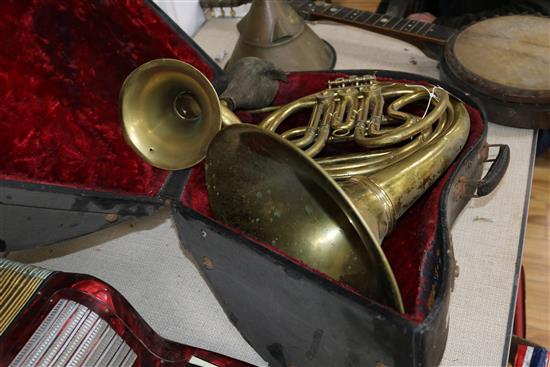 A cased horn, a French horn, a banjo etc (4)